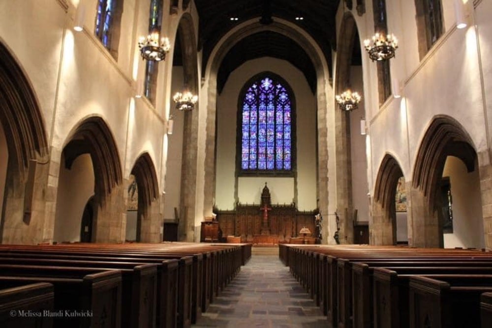 person standing inside yellow and white church